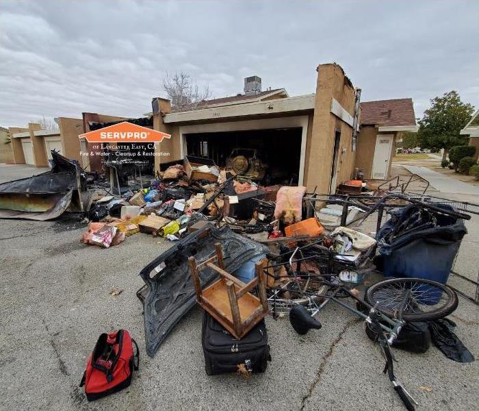 burned garage with items laying across concrete