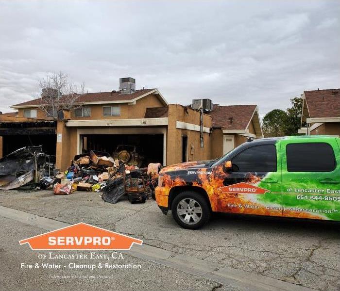 SERVPRO truck side by side with garage fire